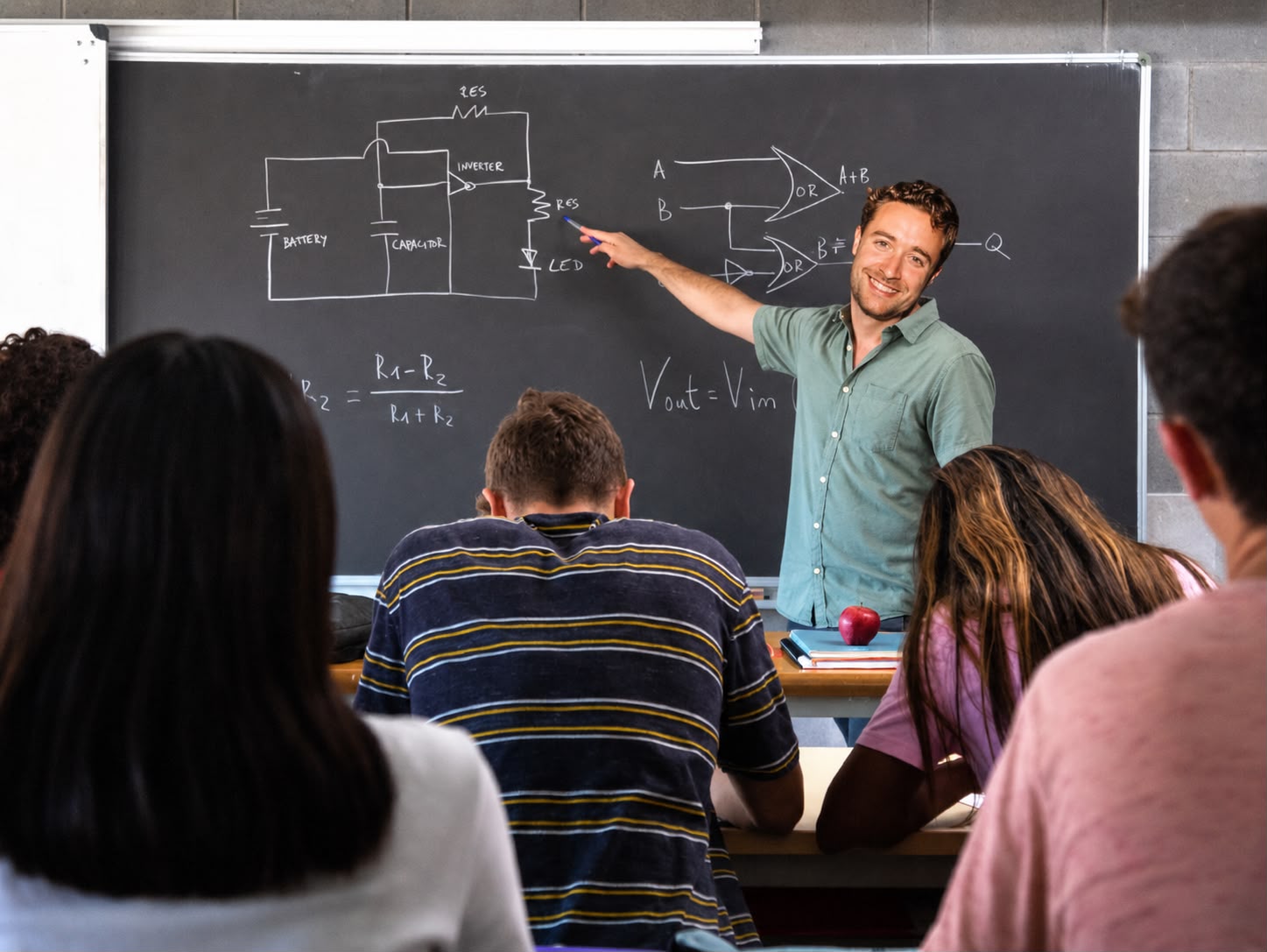 Mink teaching at a chalkboard